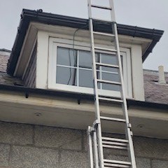 ladder against dormer window